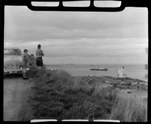 Unidentified boys watching the Stewart Island ferry from the side of the road, Bluff, Southland
