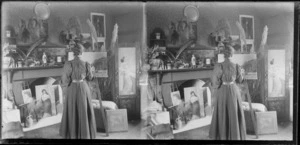 House interior featuring unidentified woman painting, Dunedin area, Otago Region, including other finished artworks, feathers, and toitoi plant ornaments