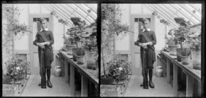 Edgar Richard Williams dressed in military uniform, including sash, and holding rifle, in the conservatory at the Williams' Royal Terrace house, Kew, Dunedin, Otago Region