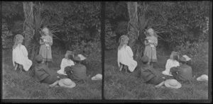 Young girl with a doll, talking to a group of two girls and two boys, Brunswick, Wanganui Region