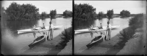 Photographer William Williams on riverbank beside canoe 'Taniwha' and including two unidentified young men in boat on the river [Tutaekuri River, Hawkes Bay Region?]