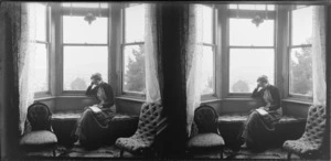 Lydia Williams reading at the window of their house, Dunedin