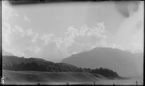 A scene including farmland and mountains, [Fiordland National Park, Southland District?]