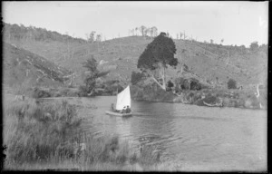 Three unidentified people sailing in a small boat on a river [near Pounawea, Catlins?]