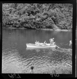 Dean Jack Eyre, Minister of Tourism, Health and Resorts, boating down the Whanganui River in the company of three other unidentified men
