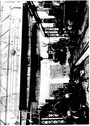 INTERIOR VIEW OP THE IPSWICH GOVERNMENT RAILWAY WORKSHOPS, SHOWING ONE OF THE ELEVEN CRANES  DRIVEN BY WESTINGHOUSE ELECTRIC MOTORS, INSTALLED BY NOYES BROTHERS. (Otago Witness, 23 September 1903)