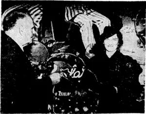 Mrs. Anthony Eden, wife of the Secretary of State for War, accepting a basket of New Zealand apples from Mr. W. J. Jordan at the New Zealand Government Offices in London on May 17, when she opened the New Zealand apple season. (Evening Post, 04 June 1940)