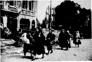 1 "■■:.'■ \ ..... : "Sport, and ' General" Photo. The town burns as the people leave for a safer area, A scene in, Belgium' when the people were fleeing before the German advance. (Evening Post, 07 June 1940)