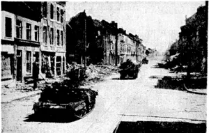 A ruined street in Louvain, with British tanks passing through. (Evening Post, 07 June 1940)
