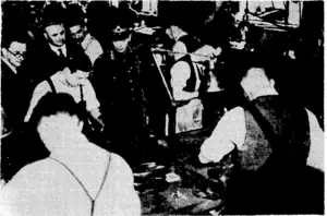Sport and,General"-Photo. The King,:witJyMr.lHerberl\Morrison- (extreme left),. Minister 'of-Supply; watching men at work on a recent Sunday;. morning in a ''. . small-arms factory near London- . ; v (Evening Post, 26 June 1940)