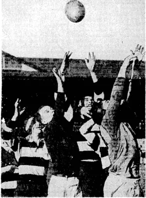 Evettlng Po&t" Photo. Oriental and University forwards reach up in a line-out at Athletic Park last Saturday, when these teams played the early match, Oriental winning by 20 points to 12. (Evening Post, 06 July 1940)
