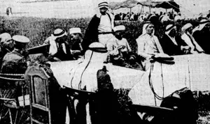 Australian niilitdry officers, seated at a table on the left, at a conference called by rival Arab tribes in Palestine, to act as arbitrators in settling a feud. (Evening Post, 15 August 1940)