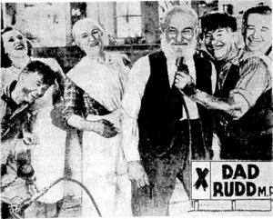 Bert Bailey seems to be giving an imitation broadcast with some local raccess in this scene from his latest film, "Dad Rudd, M.P.," which in to head the new programme at the St. James Theatre. (Evening Post, 15 August 1940)