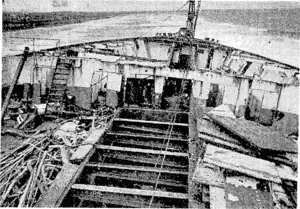 The partially-demolished forepeak of the Port Bowen, showing how the steel deck plating is stripped away. The ship is being taken down plate by plate and member by member. Later the hull plating, three-quarters of an inch thick, will be similarly stripped.. (Evening Post, 21 September 1940)