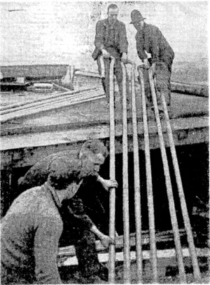 Taking out brine piping from the insulated holds of the Port Bowen for installation in the cold-storage block of the Kakariki freezing works. These works were erected during the last war, but for many years have been idle. (Evening Post, 21 September 1940)