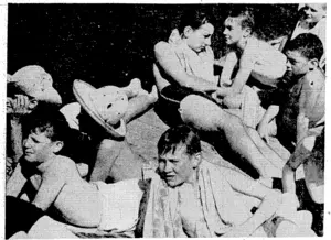Sunbathing on the boards at Te Aro Baths on a recent sunny afternoon. (Evening Post, 27 January 1940)
