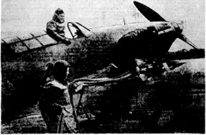 Loading a Hurricane fighter at a fighter station in France, a cold job for the ground staff under the weather conditions prevailing in recent months. (Evening Post, 19 March 1940)