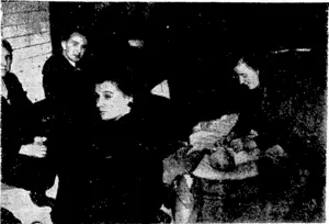 Sport and General" Photo. A mother attends to her baby on the platform of the "underground" now used at night by Londoners as a shelter from air raiders: Others are seated around waiting for the long night to pass. (Evening Post, 18 October 1940)