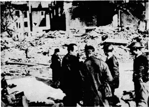 8.8.C. Photo. Mr. Robin Duff (ivithout hat) the 8.8.C. observer zvho is often heard in. New Zealand, intervieiving air-raid ivardens just after a bomb had fallen in a residential district in London. (Evening Post, 19 November 1940)