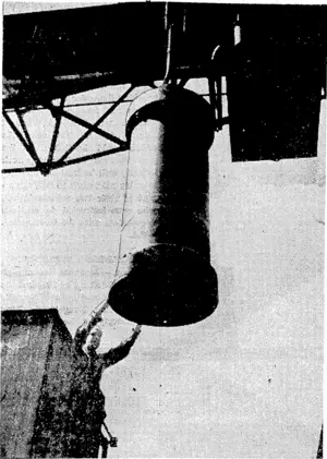 A 40001b "block-buster" being hoisted by an electric travelling crane at a Royal Ordnance factory. It is at the start of its journey to the pits, where it will be filled with high explosive. Four people can stand inside the casing of these bombs. (Evening Post, 26 November 1943)