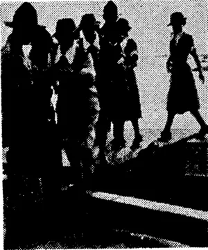 New Zealand nursing sisters arrive at Guadalcanal, stepping ashore at Lunga Beach from a landing barge. (Evening Post, 05 April 1944)