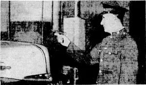 Commonwealth Peace Officer stops, at gun-point, a truck driver attempting to leave the car dock at the Consolidated Press Buildings, Elizabeth Street, Sydney, with' copies of Monday's "Daily Telegraph" (Evening Post, 22 April 1944)
