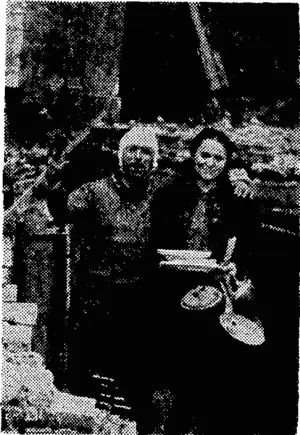 German air raiders did considerable damage in some residential areas in London recently. Standing in the midst of their wrecked home, Mr. and Mrs. Jack Benady are still cheerful. (Evening Post, 28 April 1944)