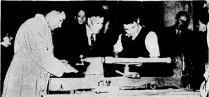 The Acting Prime Minister, Mr. Sullivan, matching a lad operate'a lathe at the Boys' Institute, following the official opening of a new workshop. (Evening Post, 18 May 1944)