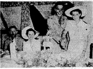 The bride and groom cutting th c cake after their wedding in the Protestant Chapel at Noumea. Seated are Captain F. Barrowclough and Private Joyce Willett. . , (Evening Post, 30 June 1944)
