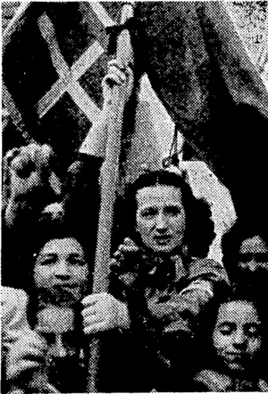 The head of a procession of women who marched through the streets of, Rome to greet the Allied leaders as they passed through the city on their way to the Capitol to hold a conference after the Allied occupation. (Evening Post, 28 July 1944)