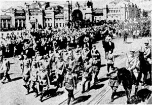 German generals and 57,000 German soldiers marched through Moscow in a march ■of triumph—as prisoners of tvar. Flanked by mounted Russian guards, the group of German generals at the head of the procession is seen passing the Bielorussian raihvay station. Vast croivds lined the streets through which the Germans were marched.. (Evening Post, 12 August 1944)
