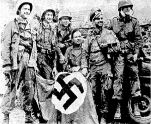 Six United Stales paratroopers, with a Nazi battle-flag, caps, steel helmets, and other trophies. After landing behind the enemy lines near the village of Orglandcs, in Normandy, they tverc captured, but were rescued shortly afterwards by Allied forces. (Evening Post, 12 August 1944)