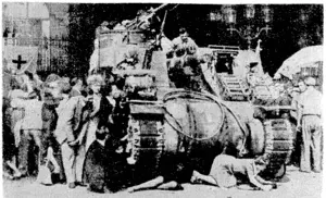Parisians taking cover behind and > beneath tanks of the French Armoured Division when German snipers fired from Notre Dame just before the thanksgiving service ivhich ivas attended by Genera. de Gaulle. !. . (Evening Post, 04 September 1944)