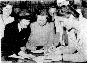 Scene in a city factory yesterday when two women workers, both with sons in the forces^ purchased Victory Bonds to the value of £25 each. (Evening Post, 09 September 1944)