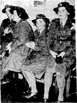 W.A.A.C.s who recently returned from a Pacific station listening to an address of welcome by the Minister of Defence, Mr. Jones. (Evening Post, 04 January 1944)