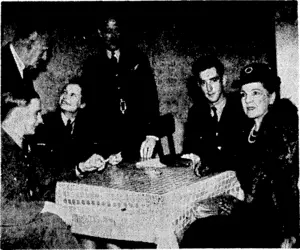 Lady Newall, wife of the Governor-General of New Zealand, with the High Commissioner, Mr. Jordan, and Dominion airmen at the New Zealand Forces' Club, Charing Cross Road, London. (Evening Post, 06 January 1944)