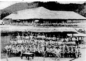 The Bourail Club and its builder s. Top, general view of the native-style club built for the New Zealand Forces at Bourail, New Caledonia. The picture below includes members of the Pioneer platoon who helped in various ways to- build the club. Sixth from the left, in the front row, is the platoon commander, Lieutenant Hoilier, and next to him, wearing a cap, is Captain A. E. Enwright, Assistant Patriotic Fund Board Commissioner. } ■ (Evening Post, 03 February 1944)