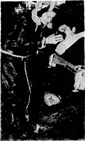 Sister Dorothy Li Barloiv, American Red Cross nurse, attending to a wounded soldier in a first-aid aircraft. They are being flown to a base hospital. (Evening Post, 23 March 1944)