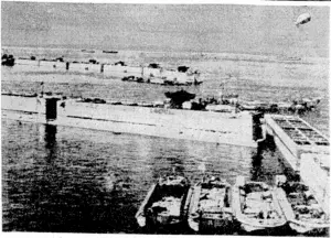 British Official rhotograph, VIA BEAM WIRELESS. Concrete caissons, prefabricated in Britain and towed across the Channel to form a breakwater for an artificial port on the Normandy beaches at Arromanches, (Evening Post, 28 October 1944)