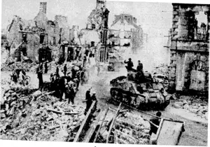 British tanks advancing through Flers, which had been shattered in the Allied offensive in Normandy. (Evening Post, 30 October 1944)