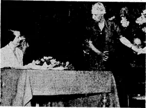 Lady Elliott presenting a hand-painted Chippendale desk and stool tor Mrs. Hislop at the gathering in honour of Mr. T. C. A. Hislop, . for 13 years Mayor of Wellington. (Evening Post, 31 October 1944)