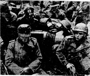 U.S. Office of War Information Hadiophoto. Colonel Gerhard Wilck, commander of the Nazi garrison at Aachen, sits ivith bowed head beside the American driver of a jeep after his formal surrender of the city. (Evening Post, 04 November 1944)