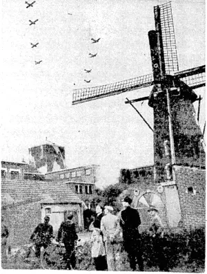Villagers of Volkenswaed, south of Eindhoven, in Holland, watching Allied planes and gliders passing overhead to support the British airborne army already landed on German territory. (Evening Post, 22 November 1944)