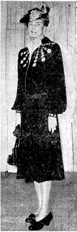 Mrs. Roosevelt's inaugural ensemble. A Potomac navy crepe dress, the neckline accented ivith blue faille and with long, full sleeves and tight cuffs. (Evening Post, 07 February 1945)