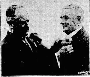 Crown Studios. The Chief Justice (the Hon. C. P. Skerrett) being decorated with a Scout- badge fay the District Commissioner (General Sir Alfred Robin, K.C.M.G., C.8.) at the Scout Rally at tha Basin Reserve last Saturday. (Evening Post, 12 April 1926)