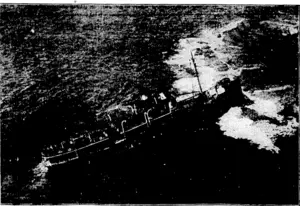 Australian United Frew Photo. An airplane photograph of the steamer Meritnbula, which went ashore on the rocks near Nowra, New South Wales, on 24th March. At the stern of the vessel may be seen the ship's boats engaged In landing the passengers, no lives being lost. TTie Wrreck took place in a heavy rain storm at I o'clock in the morning. (Evening Post, 09 April 1928)