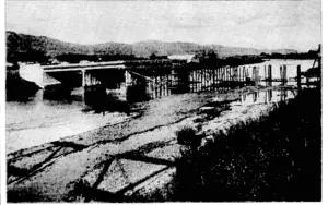 The new concrete road bridge over the Hurt River, approximately hulf-finished, will greatly improve the entrance to Lower Hutt by setting rid of some very awkward bends and providing a wider route than the present wooden bridge. The western end (on the right of the photograph) opens upon Railway avenue, and at the other end new roading will be provided. The concrete piles upon which the piers rest, some of which are shown completed, have nearly all been driven, by a machine which is out of sight at the right. Tho wooden piles aro for supporting tho timber false-work used in constructing the concrete piers and decking. The new bridge is only a few chains downstream from the present ono, the shadow of which is seen in the foreground. (Evening Post, 18 May 1928)