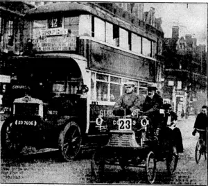 Sport and General, Photo. R.r" F- H- P*B"6's o|d.motor-car "Bonz," first run In 1900, and still going strong. Although 28 years old nearly all the parts, including the back tires, are still In use. It Is here seen beside a modern motor-bus running through the streets of London. (Evening Post, 18 May 1929)