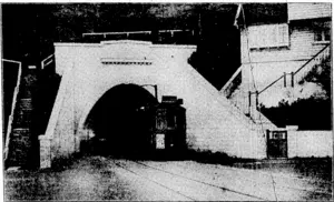 V; : ' ■ Y.'Y'.-- V V ■, "& &!***>#? v**o. The loin-tooked-for tramway service between the city and the growing suburb of Northland was inaugurated this morning. The photograph shows «m cf <*• first trams issuing from the Northland portal «* the tunnel, which was spatially built to accommodate the; service. (Evening Post, 04 June 1929)