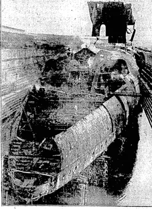 Sport and.' General, Photo. BREAKING UP THE SEYDLITZ.—The Gernian warship,in dock at Rosyth, where, she is being broken up after being' raised from the bottom of the harbour at Scapa Floiii... (Evening Post, 14 September 1929)